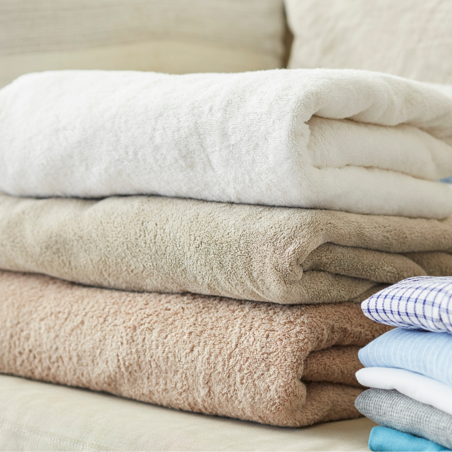 Neatly folded clean towels representing professional wash and fold laundry services
